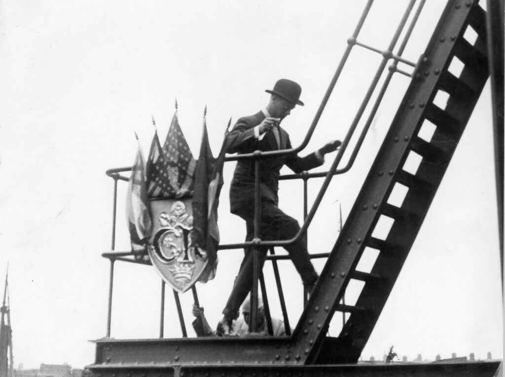 19th July 1928: Edward, Prince of Wales climbing up to the control cabin of Corporation Bridge during the opening ceremony.