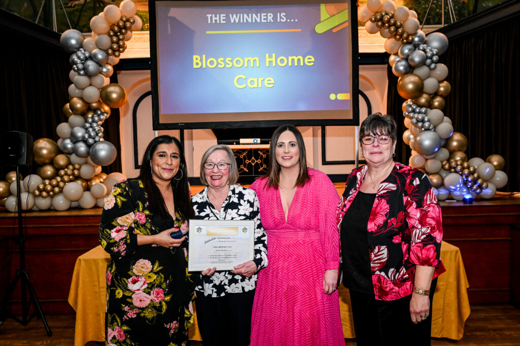 Blossom Home Care staff collect the Business in the Community Award