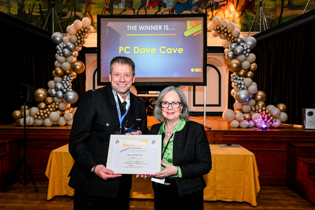 Liz Parry presents PC Dave Cave with the Good Neighbour Award