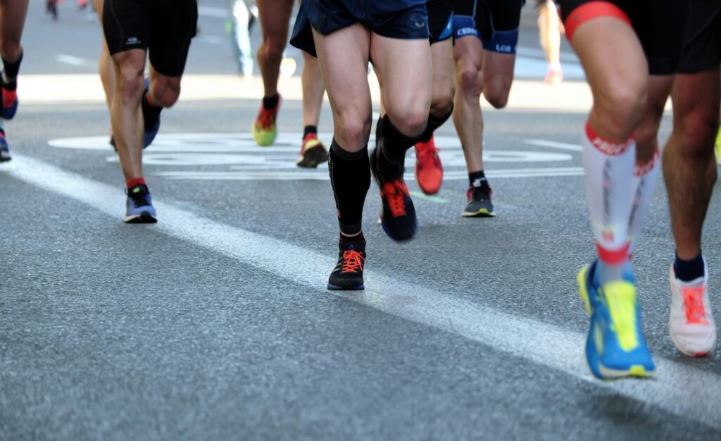 Close up of people's legs and feet as they are running