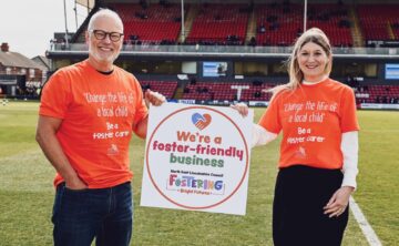 A photo of GTFC Chairman, Jason Stockwood, receiving the Fostering-Friendly Business kitemark from Director of Children's Services at North East Lincolnshire Council, Ann-Marie Matson.
