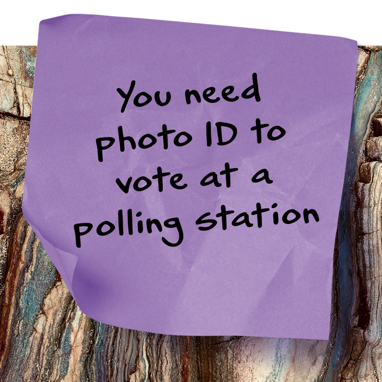 Post it note with the words "You need photo ID to vote at a polling station" on it