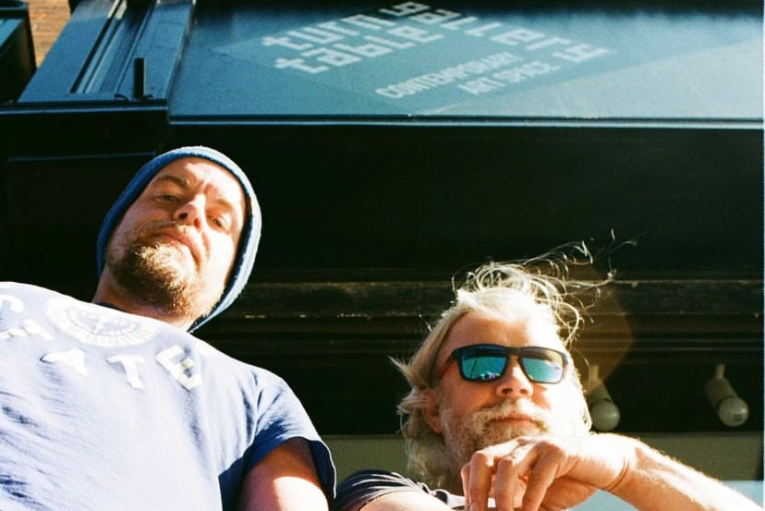 Two people smiling outside the Turntable Gallery in Grimsby