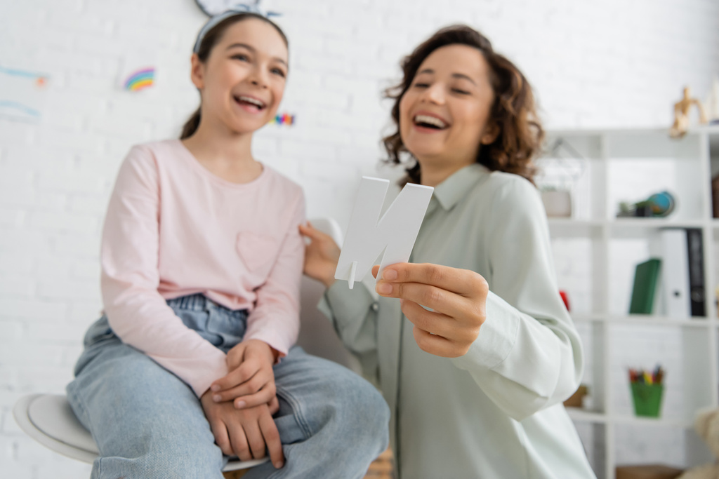 Woman and young girl laughing together