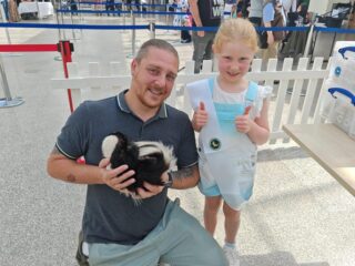 Two people holding a pet