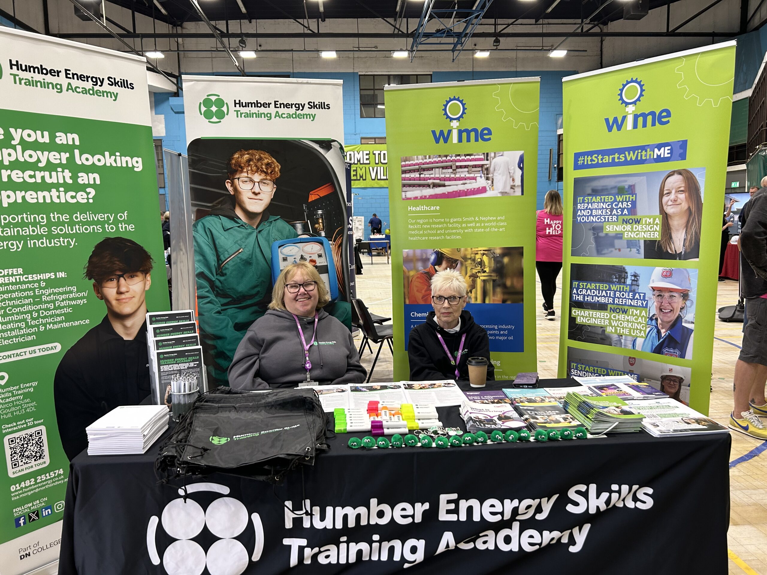 Two women stood at a stall at a careers event