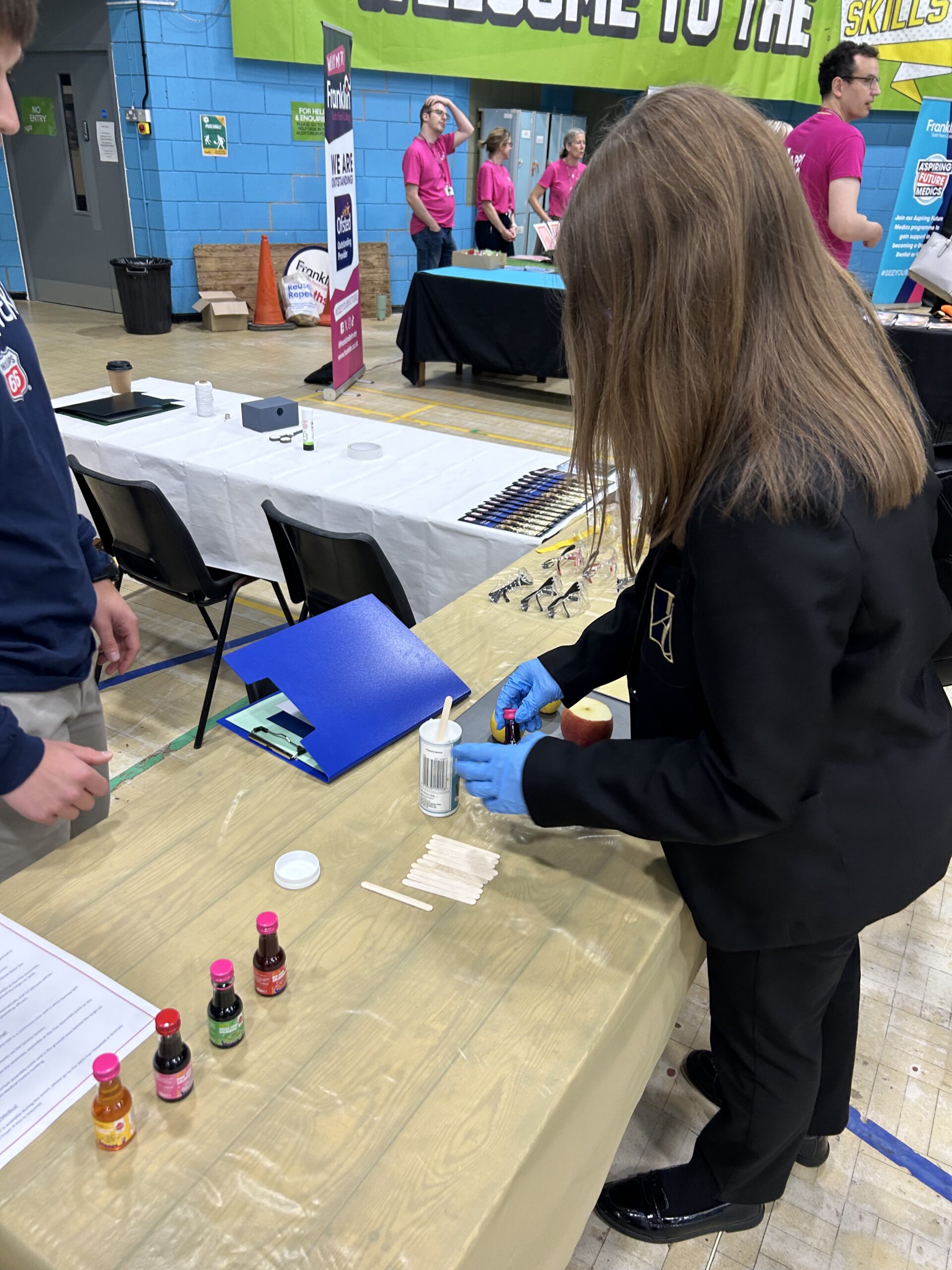 Young adult doing an experiment at a careers fair