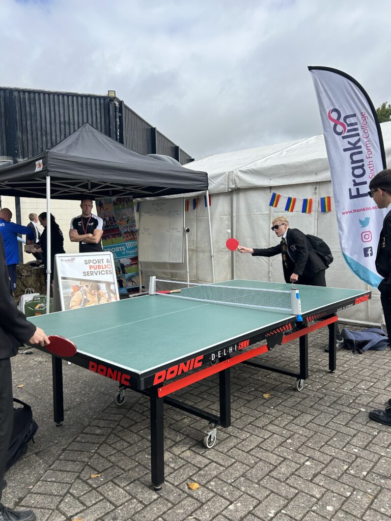 Students playing table tennis at a careers event