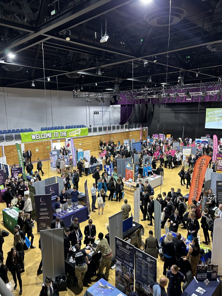 A busy auditorium with students in at a careers event