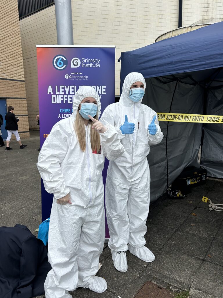 Young adults wearing white overalls at a Careers Event for forensic science