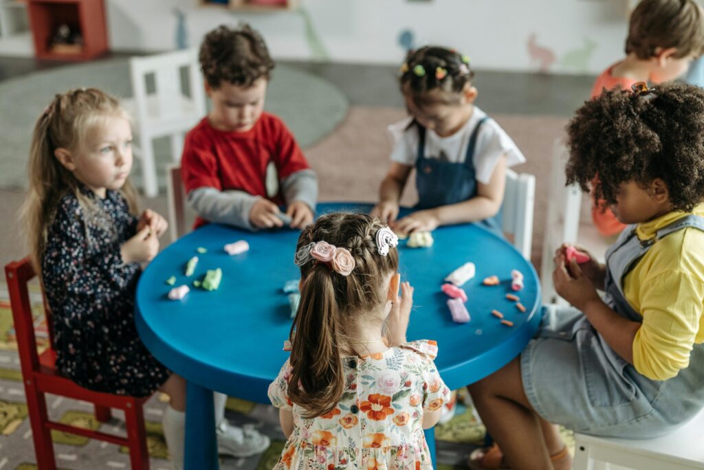 Young children sat around a table playing