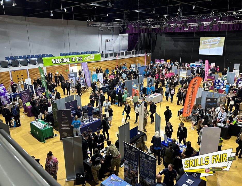 A busy auditorium with students in at a careers event