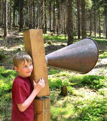 Child stood next to an interactive play area with a horn