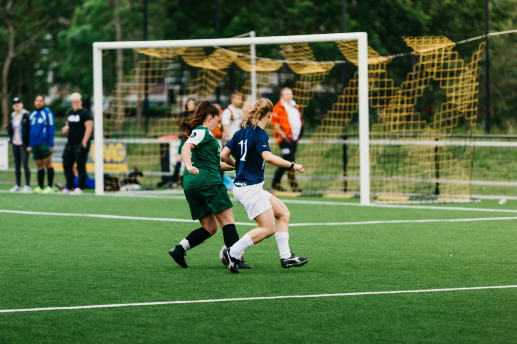 Two girls playing football