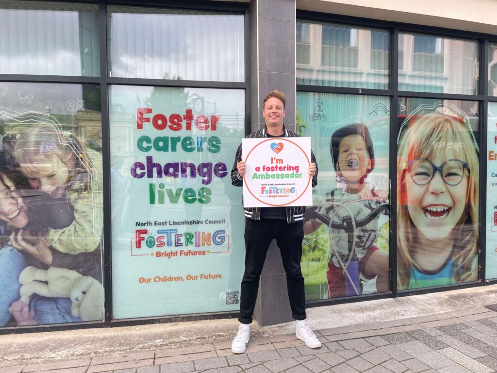 A photo of film director, Jack Spring, posing with a Fostering Ambassador kitemark