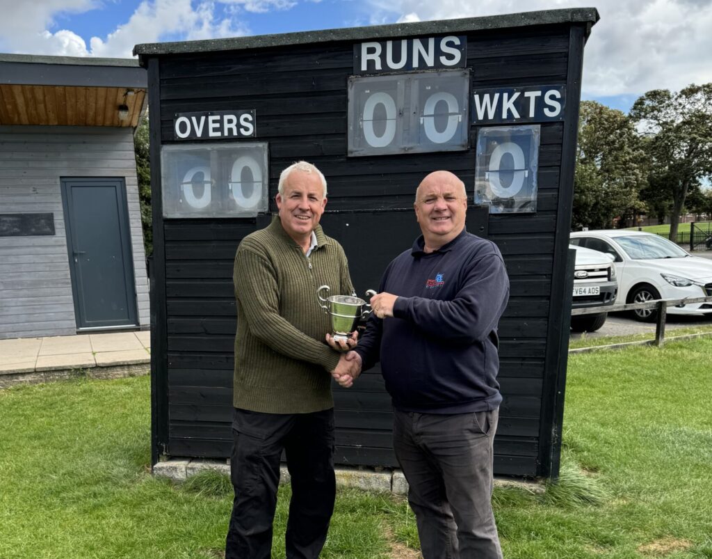 Waste Leader at North East Lincolnshire Council and Treasurer of Grimsby and Cleethorpes Cricket League shaking hands with the Barrett Cup