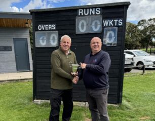 Waste Leader at North East Lincolnshire Council and Treasurer of Grimsby and Cleethorpes Cricket League shaking hands with the Barrett Cup
