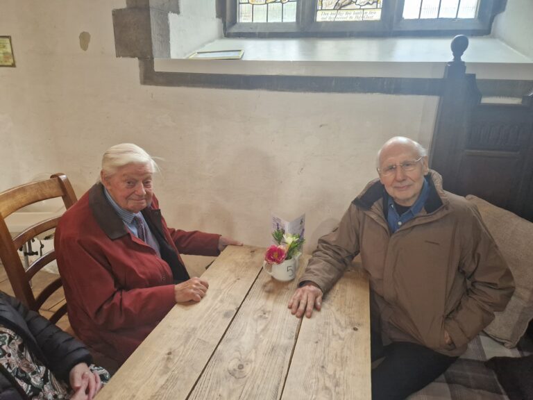 Gordon Smith and Harold Gosney sat at a table