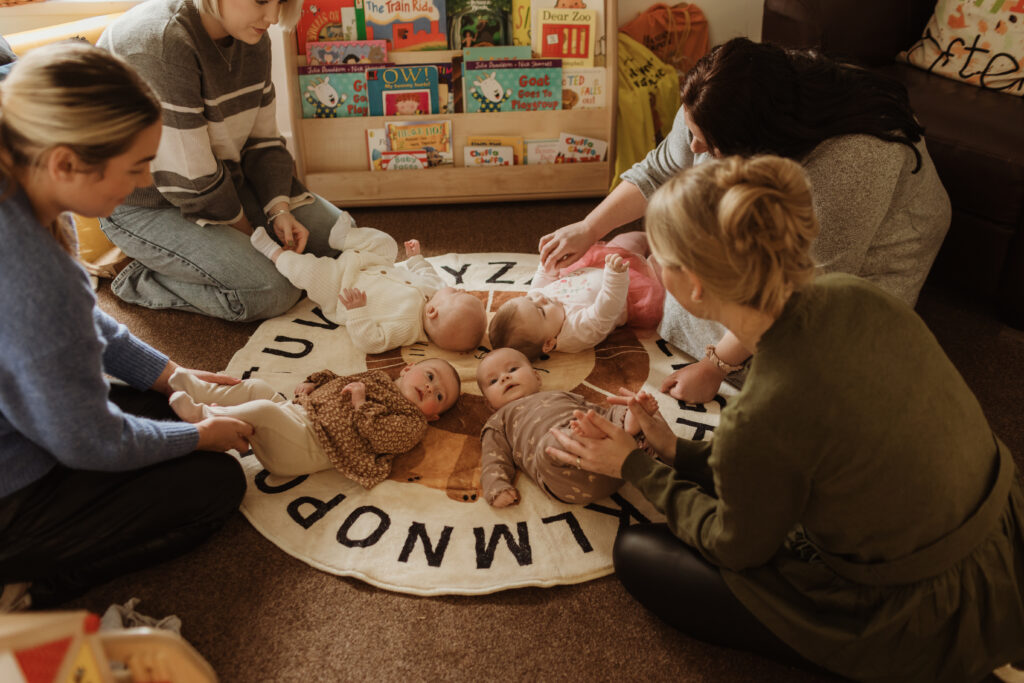 Photo of mums playing with babies