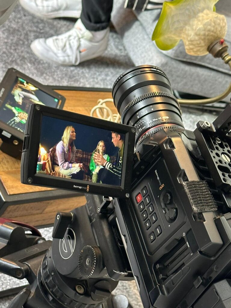 A camera shot of Poppy speaking to a social worker.
