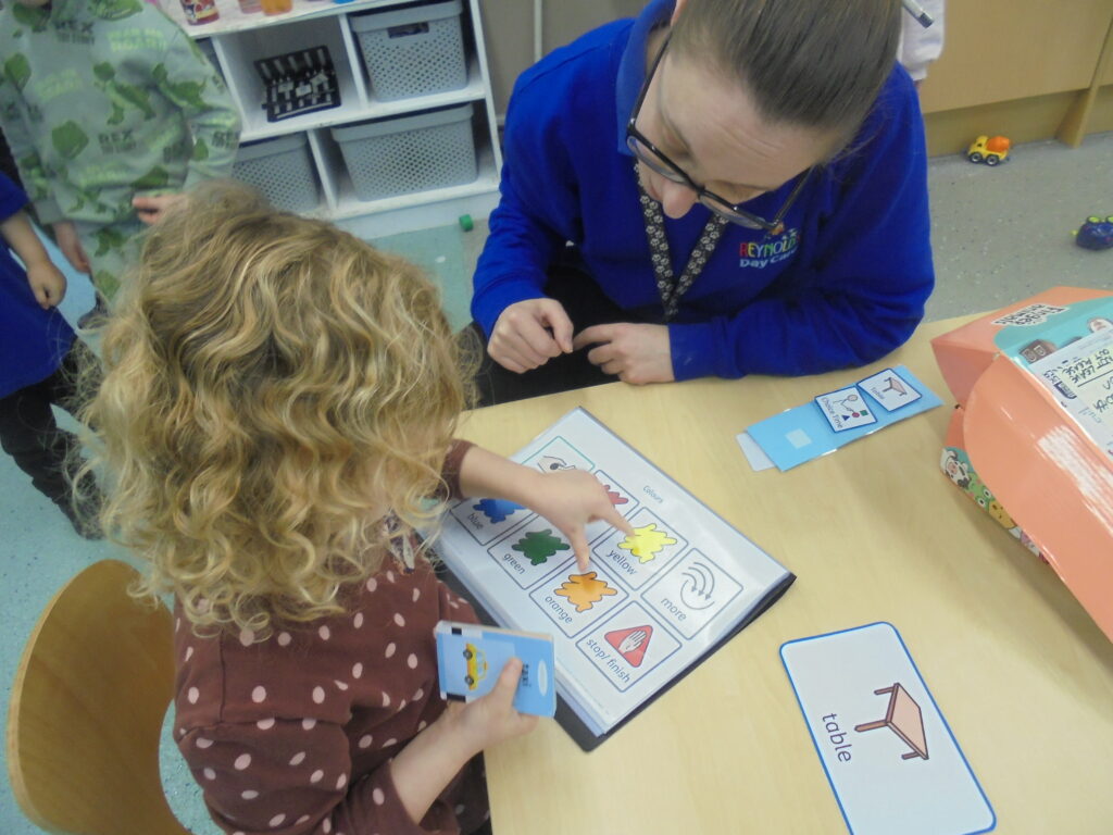 Young child using PIP to learn in nursery