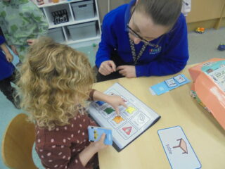 Young child using PIP to learn in nursery