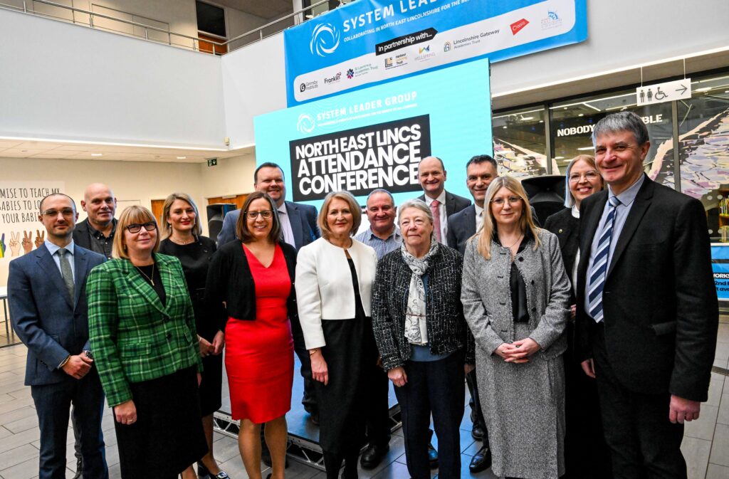 A photo of speakers, guests and members of the System Leader Group at the Attendance Conference.