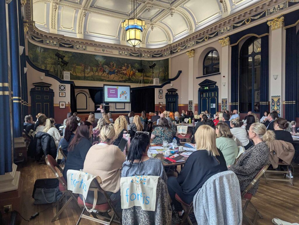 Group of people listening to speaker at conference held at Grimsby Town Hall
