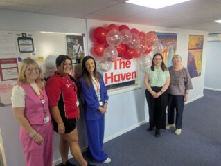 A photo of Haven and Council staff posing by the Haven sign