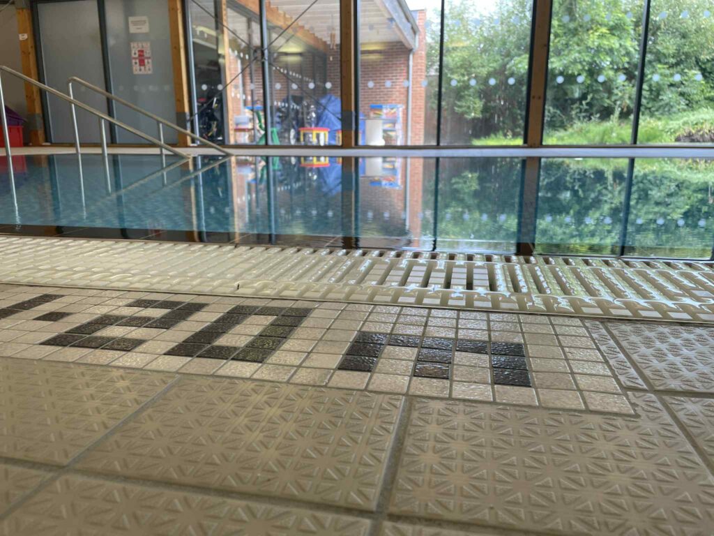 A photo of the hydrotherapy pool taken from one edge, showing the 1.2m mark on the tiled floor.