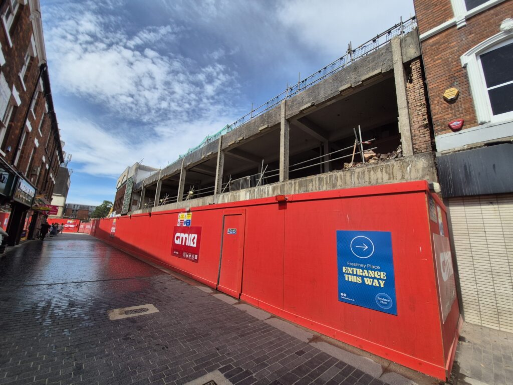 Former BHS building behind site hoardings