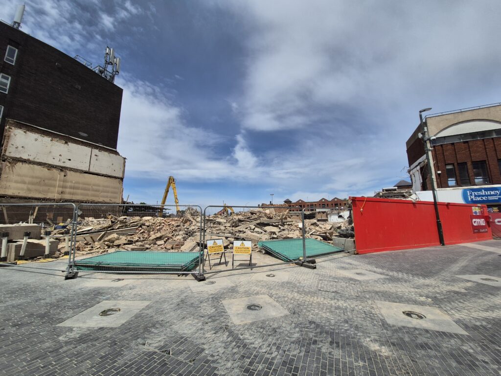 Rubble behind site hoardings