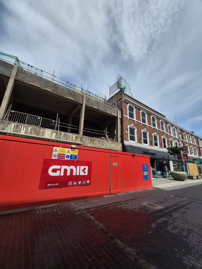 Former BHS building behind site hoardings