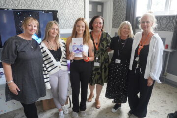 Courtnay the author of the book stands in the centre with 5 women next to her