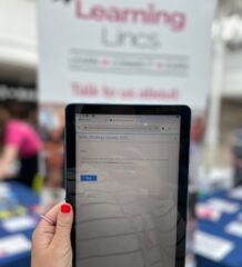Hand holding a tablet with a survey on