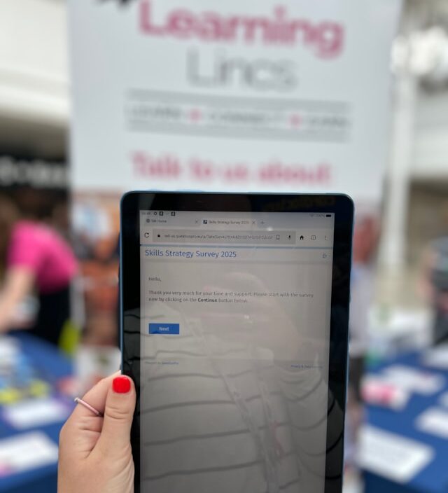 Hand holding a tablet with a survey on