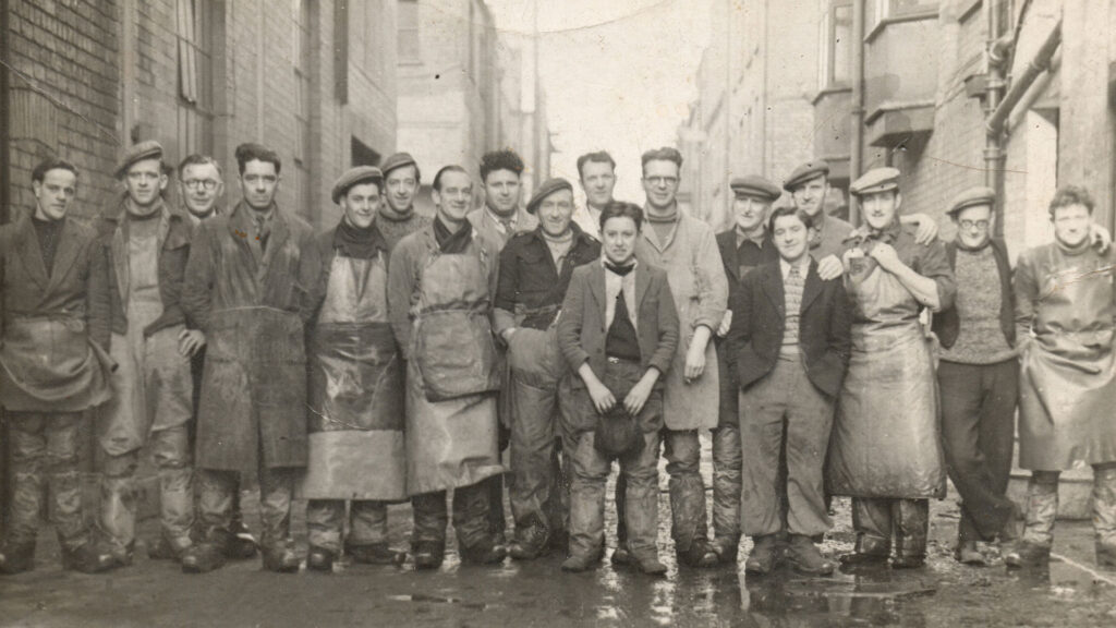 Black and white photo of men between two buildings
