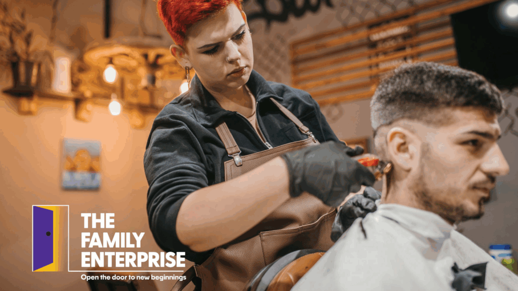 Woman cutting a mans hair