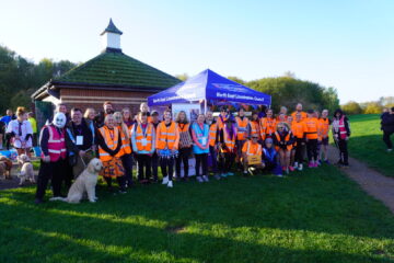 Group of people in orange vests in front of a Fostering North East Lincolnshire gazebo