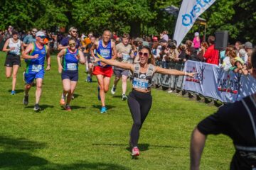 A runner celebrates at the finish line of the 2025 Orsted Great Grimsby 10K.