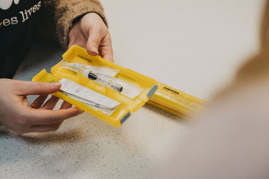 A yellow box with a syringe device in