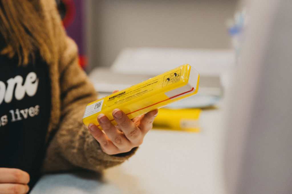 A person's hands holding a yellow box
