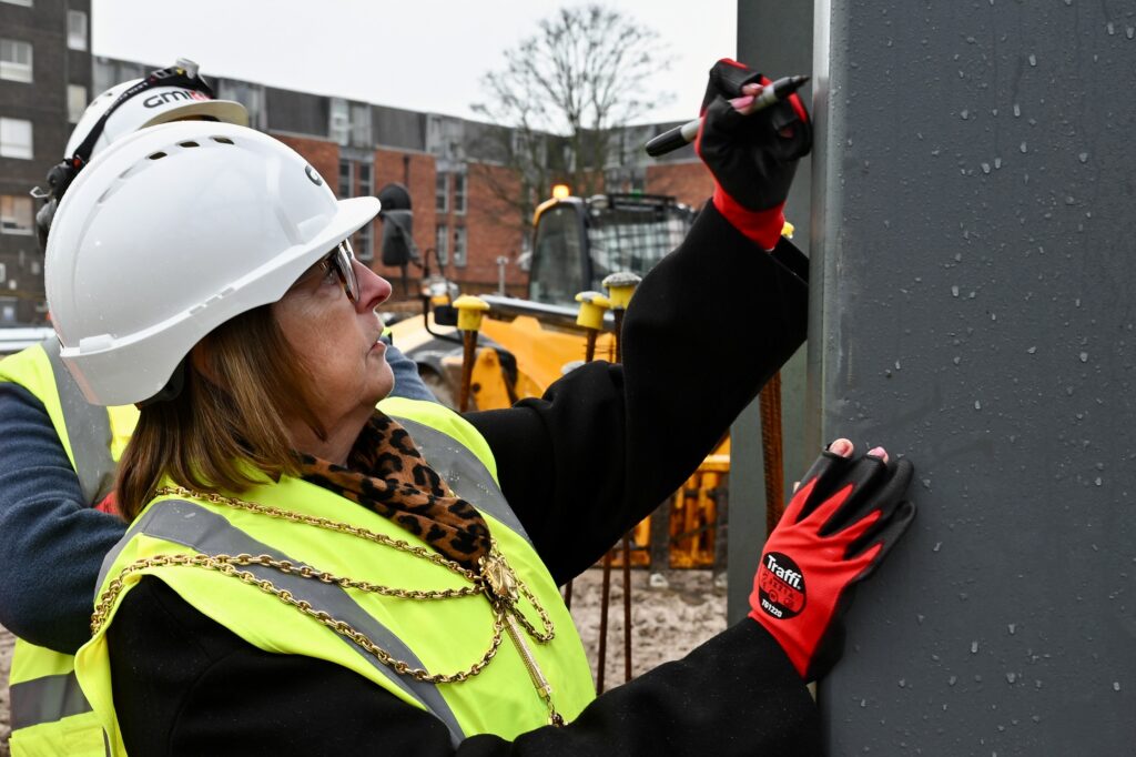 Mayor of North East Lincolnshire signing the steel at the Freshney Place development
