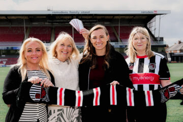 Foster Carers Kerry and Deb, CEO of GTFC Polly Bancroft and Director of Children's Services Ann-Marie Matson pose with a GTFC scarf at Blundell Park