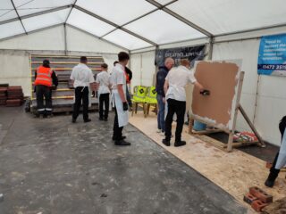 Young people having a got at plastering