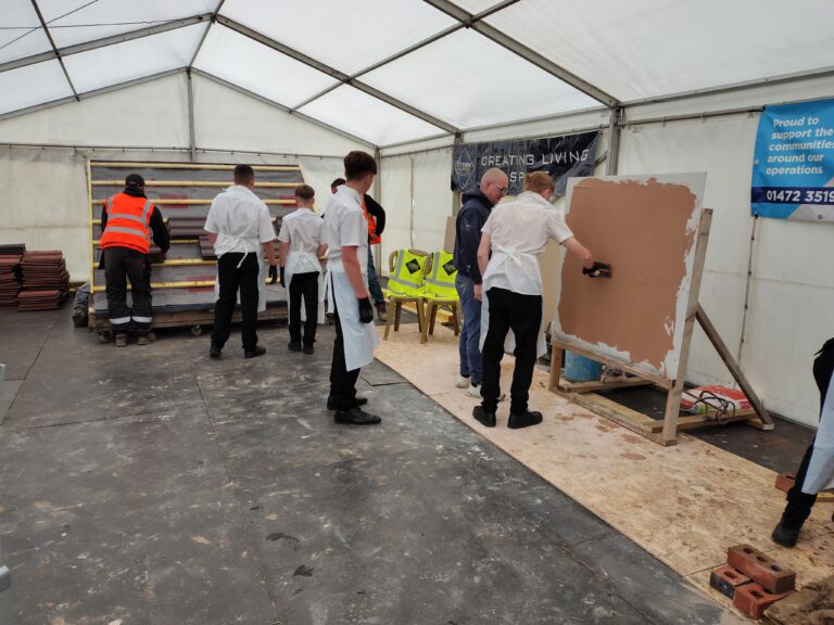 Young people having a got at plastering