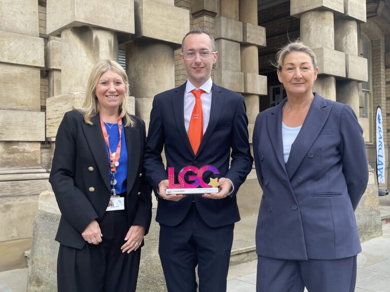 (From left) Director of Children's Services, Ann-Marie Matson, with Deputy Leader and Portfolio holder for children and education, Councillor Samuel Grice, and North East Lincolnshire Council Chief Executive, Sharon Wroot, pose with the LGC Award on the steps of Grimsby Town Hall.