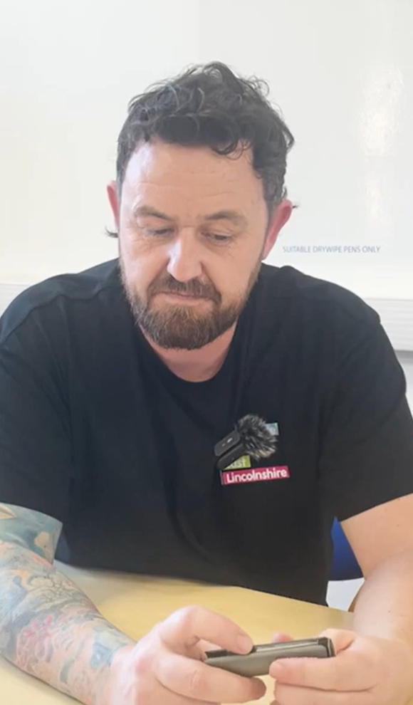 Man from smoking team showing how to use a vape