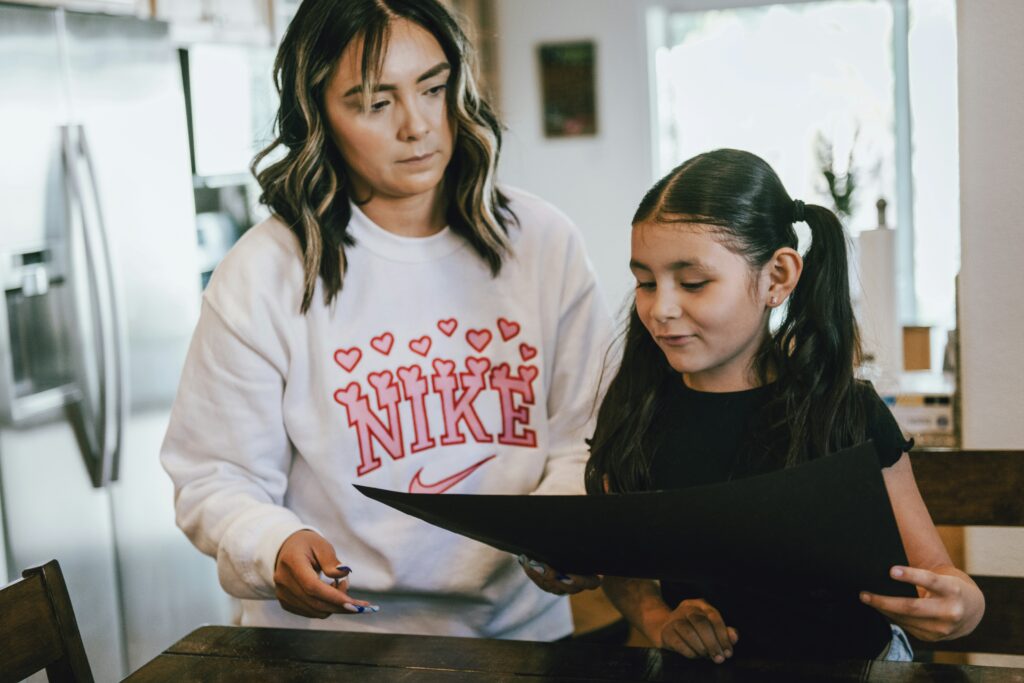 Woman showing a child something on an ipad