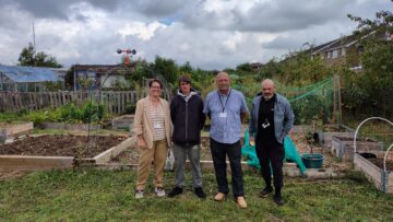 4 people stood in front of an allotment, Katie, Accommodation and Housing support lead, Nathan, resident of Swan House, Cllr Paul Batson, Portfolio Holder for Housing, Infrastructure and Transport, and Ben, support officer at Swan House.